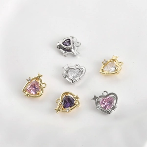 Gold and silver heart pendants with colorful cubic zirconia and star accents