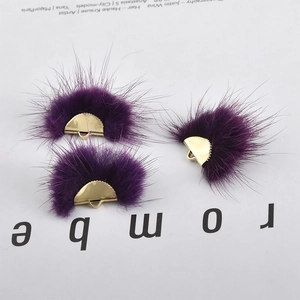 Detail view of purple mink fur fan pendants with gold metal clasps for DIY jewelry making