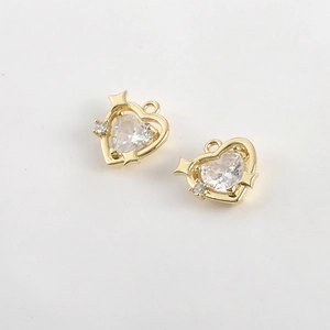 Macro view of 14k gold plated heart pendants with clear zircon and star detail