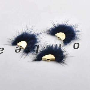 Macro shot of navy blue semi-circle faux fur charms with gold metal rings for DIY earrings