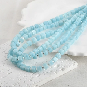 Detailed view of light blue cubic glass beads necklace with silver spacer beads