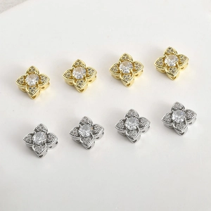 Detail of four-leaf clover jewelry beads with 14k gold plating and zircon inlay for DIY