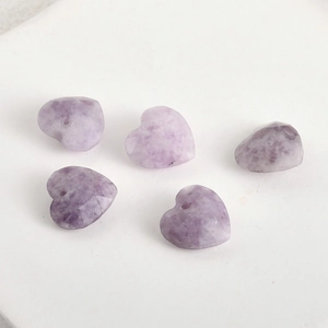 Detailed macro view of 13mm purple faceted crystal heart beads for DIY jewelry making