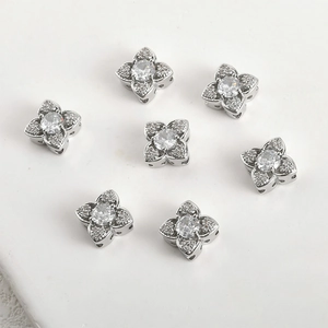 Macro shot of silver flower spacer beads with zircon settings for DIY jewelry making