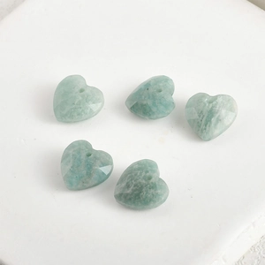 Macro view of five 13mm faceted amazonite heart charms with top-drilled holes for DIY