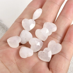 Macro view of 13mm heart-shaped faceted natural rose quartz beads for DIY jewelry