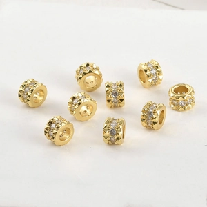 Macro view of 14k gold plated rivet barrel beads with cubic zirconia for DIY jewelry