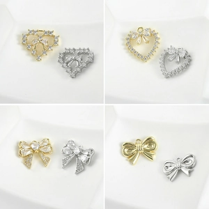 Detailed view of 14k gold-plated heart and bow jewelry charms for DIY accessories