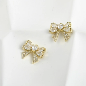Detailed view of 14k gold plated bow and heart shaped pendant with zircon stones