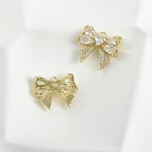 Macro view of 14k gold plated bow pendant with cubic zirconia for jewelry making