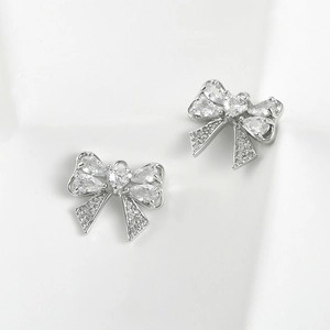 Close-up of bow knot charms with sparkling zircon stones for DIY jewelry making