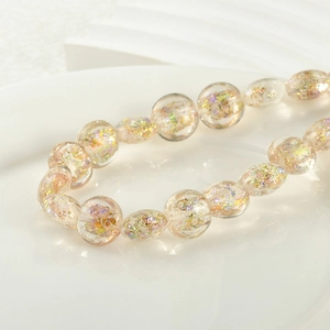 Detailed macro shot of clear glass beads with iridescent foil inside for jewelry making