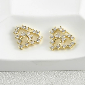 Macro shot of 14k gold-plated heart pendant with zircons and 3D bow detail for jewelry making