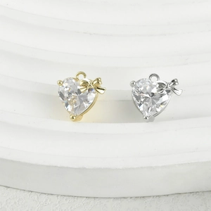 Sparkling heart-shaped zircon pendants with bow detail in 14k gold and silver plating