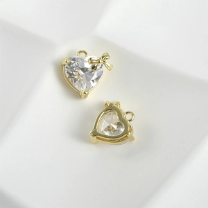 Detailed front and back view of heart-shaped zircon pendant with 14k gold bow detail
