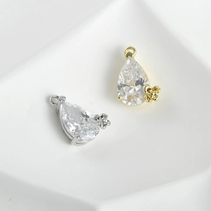 Detailed macro view of gold and silver plated drop cubic zirconia flower pendants