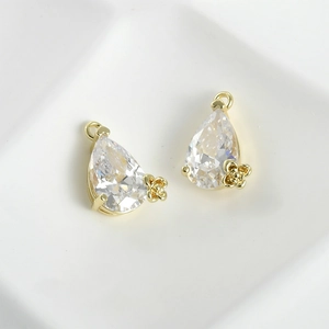 Macro view of pear-shaped zircon pendants with 14k gold plating and flower detail