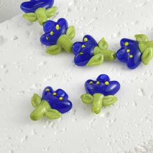 Macro view of handmade tulip glass beads in blue and green for DIY jewelry making