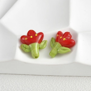 Detailed macro view of handmade red tulip glass beads for DIY jewelry crafting