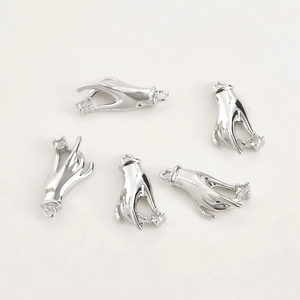 Close-up of hand-shaped silver charms holding white cubic zirconia for DIY jewelry making