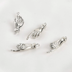 Macro shot of silver palm hand gesture pendants for DIY jewelry making accessories