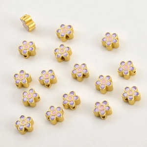 Macro detail of colorful enamel flower beads with gold base for DIY jewelry making