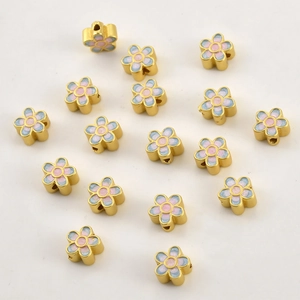 Macro shot of 18k gold plated flower beads with blue and pink gradient enamel