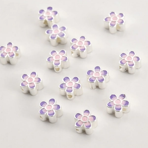 Macro detail of enamel flower beads with pink to lavender gradient for jewelry DIY