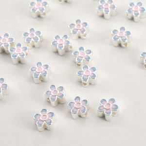 Macro shot of 18k gold plated enamel flower beads for DIY jewelry making and bracelets