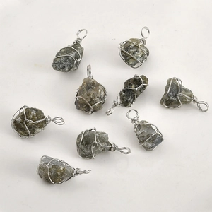 Detailed view of nine hand-wrapped natural raw stone pendants with silver wire loops