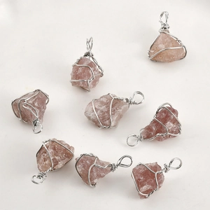 Detail of eight handmade rose quartz crystal pendants with silver wire wrap craftsmanship