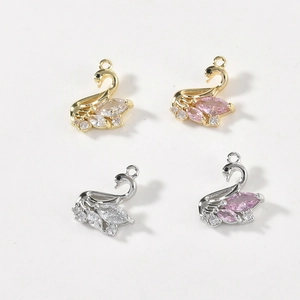 Swan-shaped jewelry pendants in gold and silver with pink and clear crystals for DIY crafts