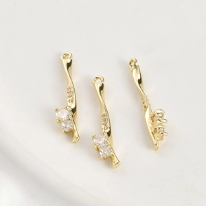 Detail of 14k gold plated rose pendants with zircon stones and twisted bamboo bars