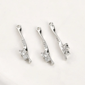 Detail of 14k gold plated twisted bar pendants with zircon rose and bamboo leaf design