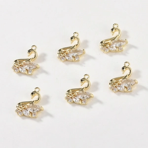 Detail of six 14k gold-filled swan pendants with sparkling white cubic zirconia stones