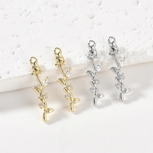 Macro detail of 14k gold plated rose bud pendants with cubic zirconia inlay for DIY crafts