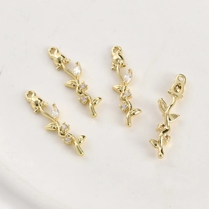 Macro detail of 14k gold plated rose pendants with cubic zirconia for DIY jewelry making