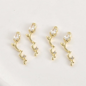 Macro detail of 14k gold-plated bamboo pendants with zircon stones for DIY jewelry making