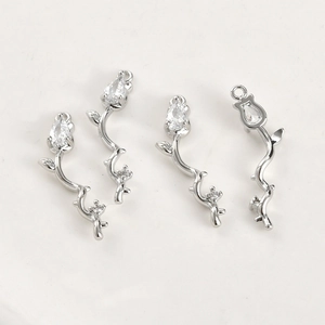 Macro view of silver flower vine pendants with cubic zirconia for jewelry making