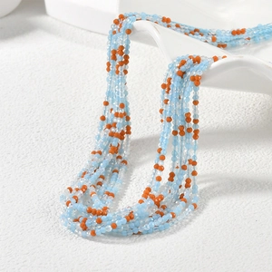 Detail of layered faceted beads in blue and orange for DIY jewelry making and crafts