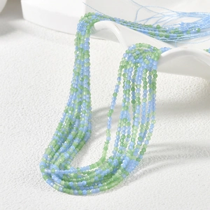 Detail of 2mm faceted light blue and green glass beads for DIY jewelry making and crafts