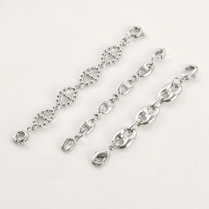 Close-up of three silver pig nose extension chains with double-ended clasps for DIY