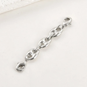 Close-up of silver pig nose chain extender with lobster clasps for DIY jewelry making