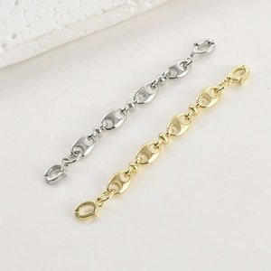 Close-up of gold and silver pig nose link extender chains with dual spring clasps