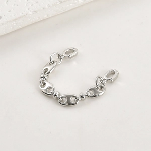 Detailed view of polished pig nose chain connectors for DIY jewelry making and assembly
