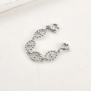 Close-up of dual spring ring clasps on a beaded silver chain extension accessory