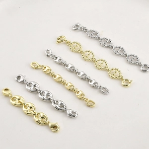 Detailed view of 14k gold-filled and silver pig nose chain extenders with dual lobster clasps