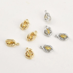 Close-up of 14k gold plated fruit pendants with yellow zircon stones and tiny crystals