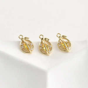 Detailed macro view of three 14k gold plated lemon pendants with yellow zircon stones