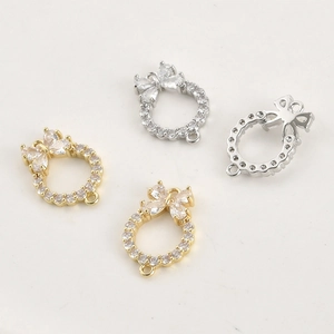 Macro detail of 14k gold-plated butterfly wreath pendants with cubic zirconia for DIY jewelry